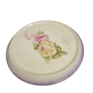 Vintage ceramic trivet with roses